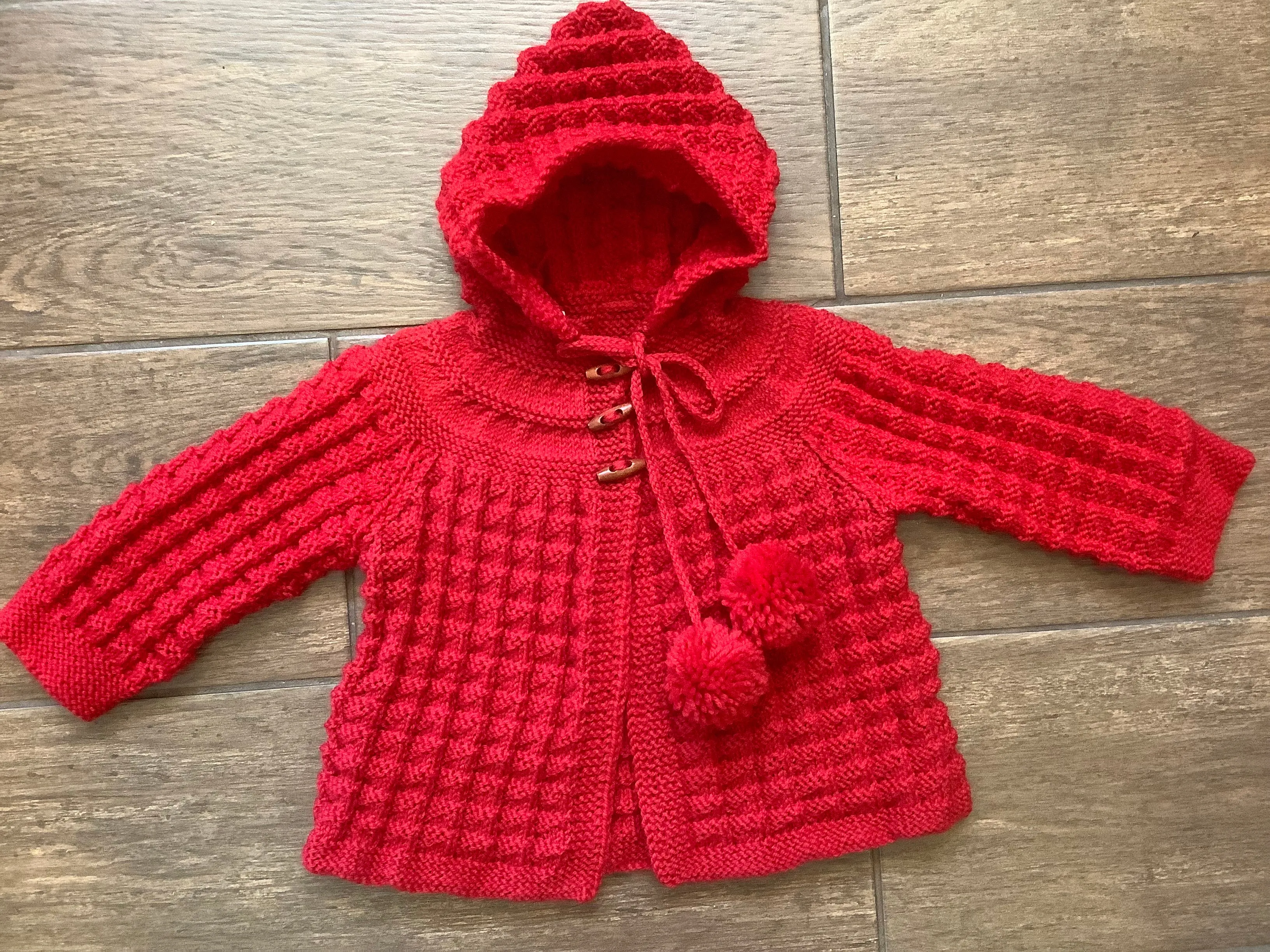 Hand Knitted Hooded Jacket with Pom Poms